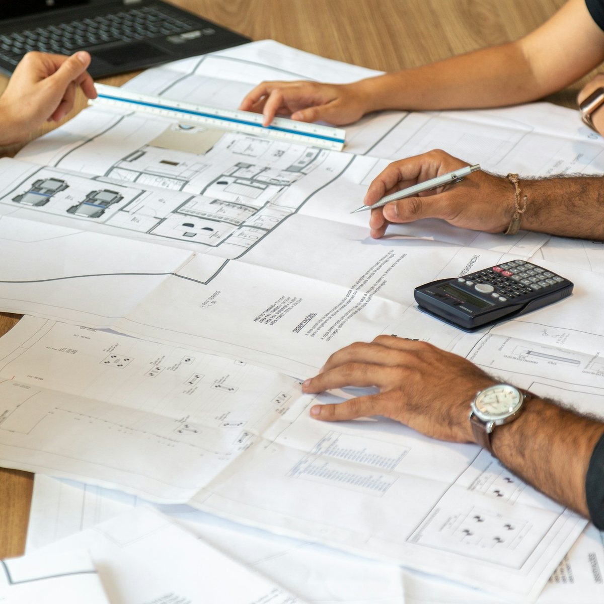 A team going through house plans together at a table